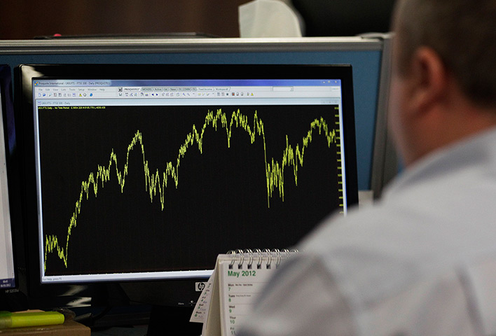 Week in business: Traders from Interactive Investor look at their computer screens