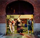 Butchers use a crane to lift the carcass of a bull at the Las Ventas Bullring in Madrid