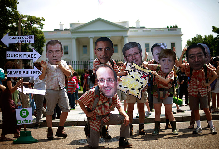 24 hours in pictures: xfam activist wearing masks depicting G8 world leaders