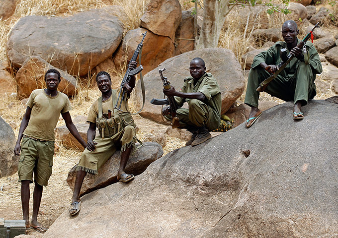 Nuba Mountains Conflict: A SPLA-N fighter holds up his rifle near Jebel Kwo village, Nuba Moutnains