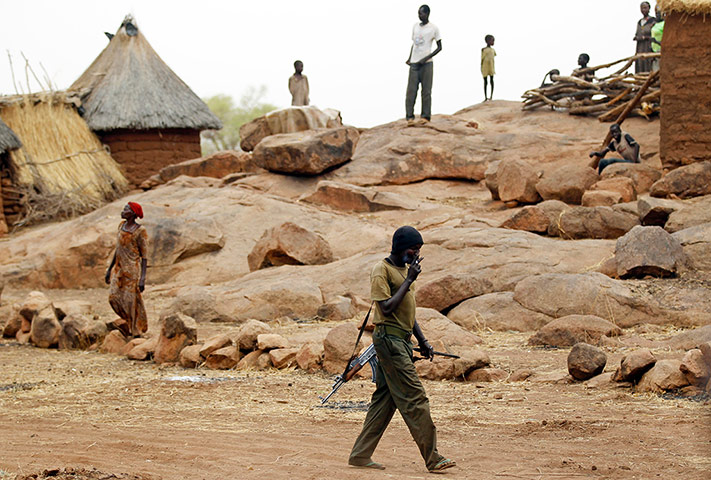 Nuba Mountains Conflict: A SPLA-N fighter walks in Jebel Kwo village, Nuba Mountains
