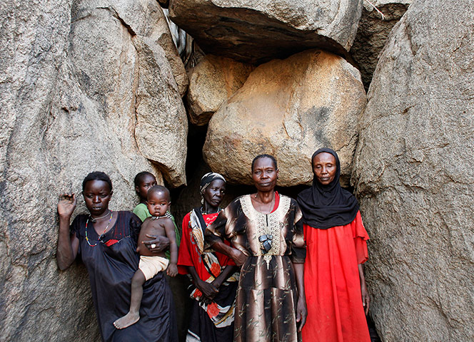 Nuba Mountains Conflict: Women stand in front of a cave in Bram village in the Nuba Mountains