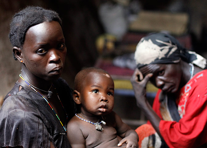 Nuba Mountains Conflict: Women stand in front of a cave in Bram village in the Nuba Mountains