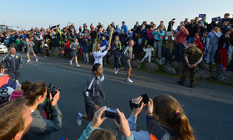 Olympic Torch Relay: Ben Ainslie handed the torch over to local surf champion Anastassia Swallow