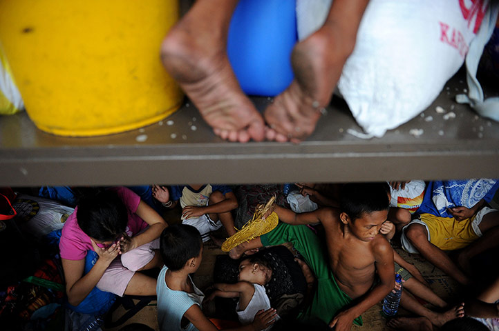 24 Hours: Victims in a sports complex in Manila after a fire engulfed a shanty town