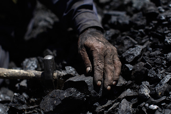 24 hours: Islamabad, Pakistan: A 69-year-old man breaks coal in a brick factory