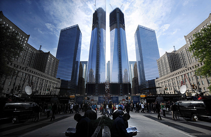 One World Trade Center is reflected in a glass wall to form twin towers