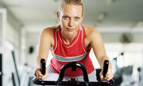 A woman on an exercise bike