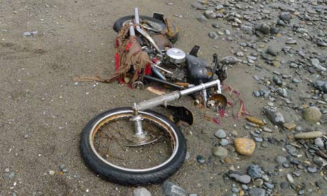 A motorbike swept away during the Japanese tsunami lies on a Canadian beach, 4,000 miles away. 