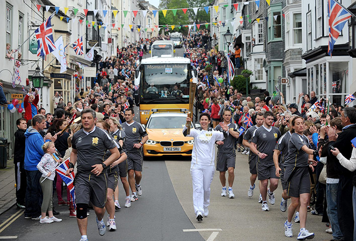 Torch relay day 2: Torchbearer 022 Leah Burch waves to the crowds