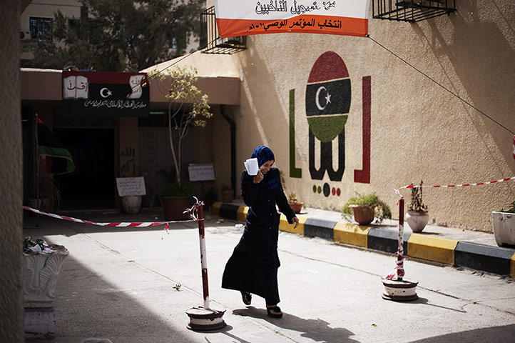 24 hours: A woman leaves a public school after registering to vote in Libya