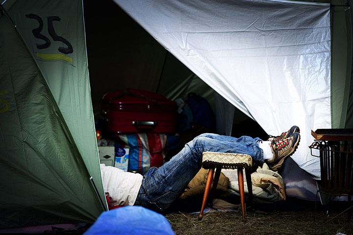 24 hours: An asylum seeker rests inside a tent outside the application center