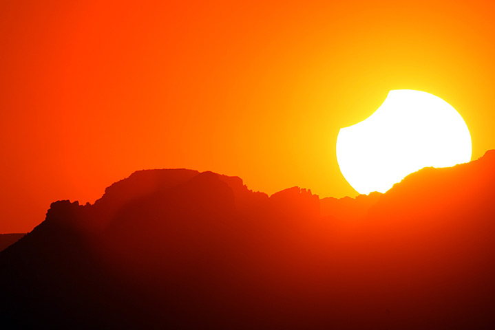 Solar eclipse: a partial eclipse as the sun sets in Grand Canyon National Park, Arizona