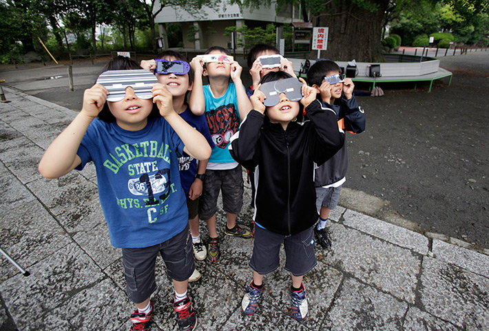 Solar eclipse: Children watch an annular solar eclipse in Fujisawa, near Tokyo