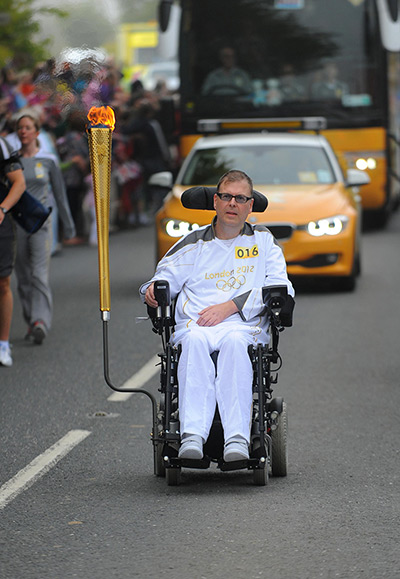 Olympic torch relay day 3: John Saunders carries the Olympic Torch between Okehampton and Merton