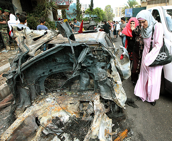 Picture desk live: A burnt out car is seen after violent clashes in Beirut, Lebanon