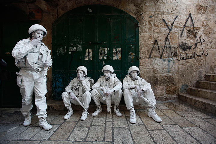 24 hours in pictures: Israeli performance artists rest during a parade marking Jerusalem Day