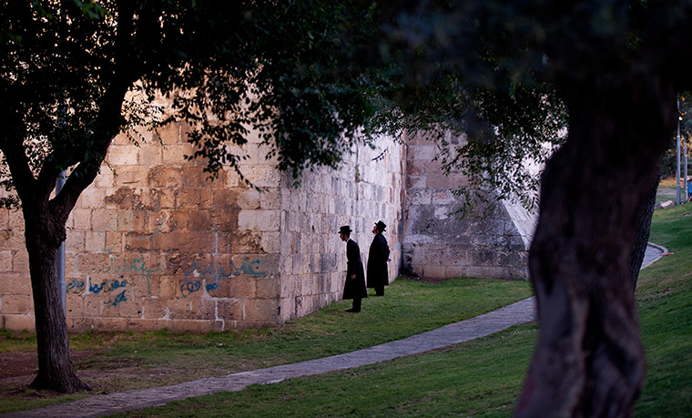 24 hours in pictures: Ultra orthodox Jewish men pray next to the walls during Jerusalem Day