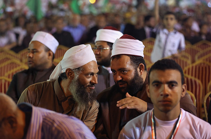 24 hours in pictures: Muslim Brotherhood members sit during a final campaign rally, Egypt