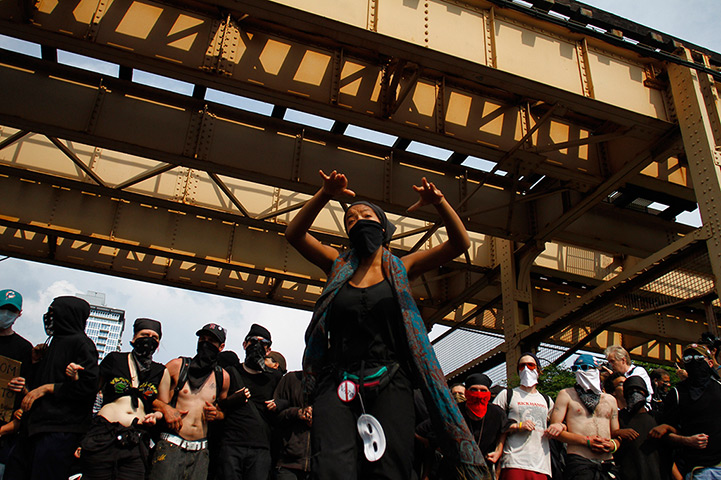NATO summit protests: Demonstrators link arms as they protest 