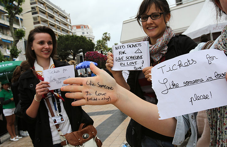 Cannes day 6: Girls hold signs asking for tickets to see Like Someone in Love
