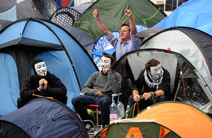 David Cameron celebrates: Demonstrators at Occupy London haven't noticed David Cameron's in the camp