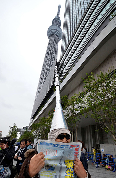 Tokyo Skytree tower opens: A man wears a hand-made hat at the foot of the tower