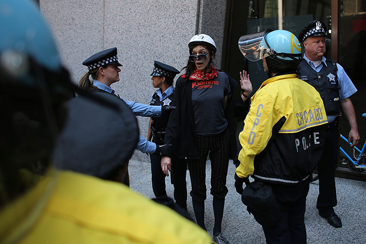 24 hours in pictures: Police detain a woman during demonstration aganinst NATO summit, Chicago