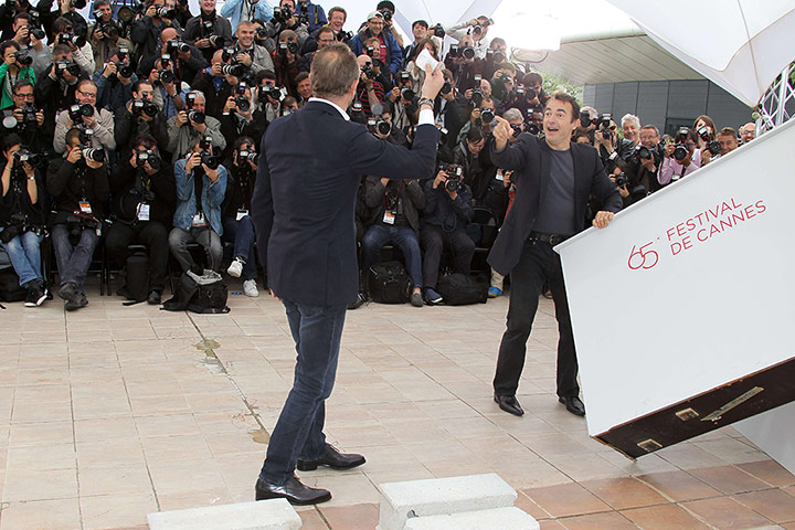 Cannes day 7: Actor Benoit Poelvoorde waves a piece of paper about 