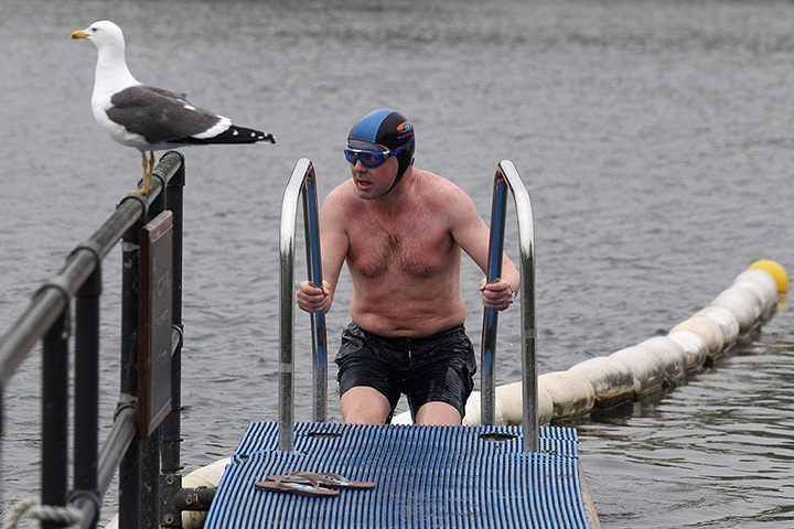 UK weather: Early morning swimmers in the Serpentine lake