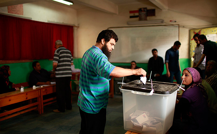 Egypt elections: A man  casts his vote at a polling station in Cairo