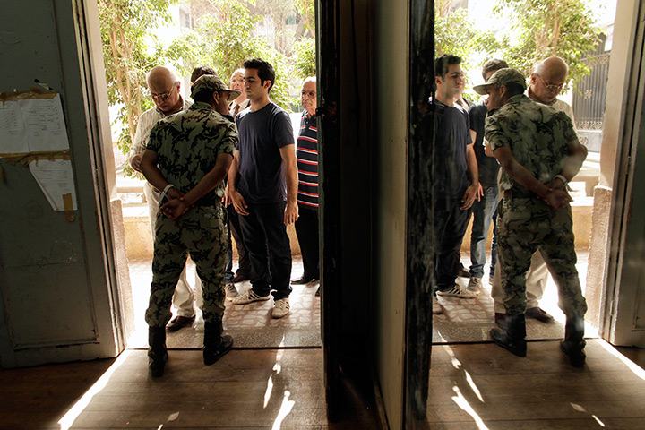 Egypt elections: An Egyptian Army soldier stands guard inside a polling station in Zamalek