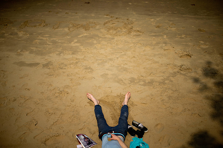 UK heatwave: A man soaks up the sun on the south bank of the River Thames