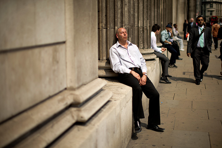 24 hours in pictures: A man soaks up the sun outside the Bank of England