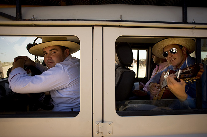24 hours in pictures: A pilgrim plays guitar in car heading to the shrine of El Rocio