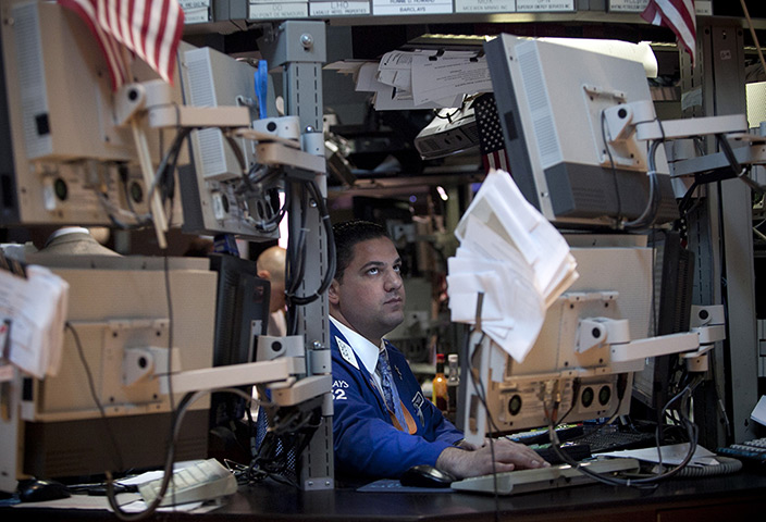 24 hours in pictures: A trader works on the floor of the New York Stock Exchange