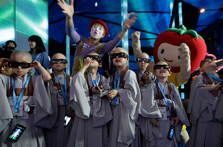 24 hours in pictures: Shaven-headed young boys wearing 3-D glasses in Seoul