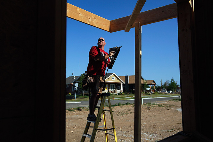 FTA: Joe Raedle: A man helps build a Habitat for Humanity home where a home was knocked down
