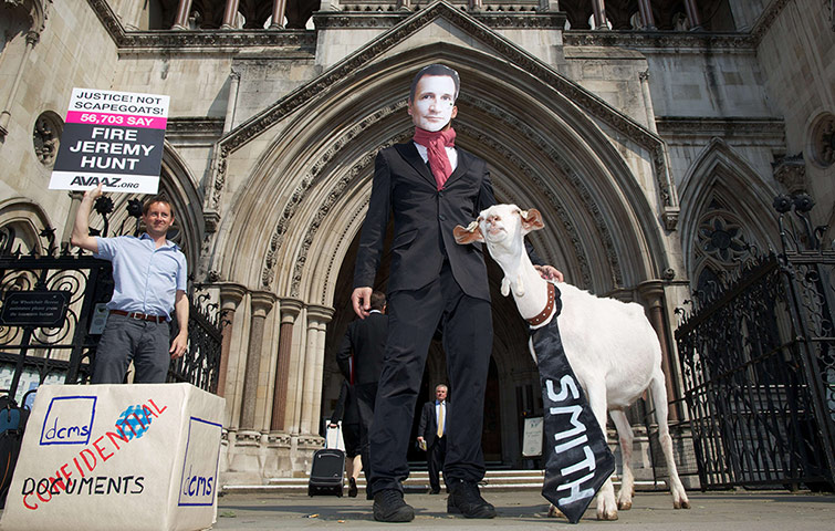 Picture Desk Live: A demonstrator wears a mask depicting Jeremy Hunt