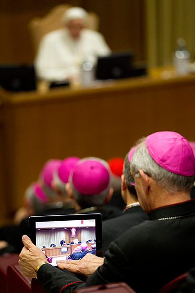 Picture Desk Live: A bishop uses his tablet to take pictures of Pope Benedict XVI 