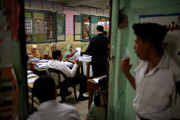 24 hours in pictures: Officials count the ballots after the polls are closed in Cairo