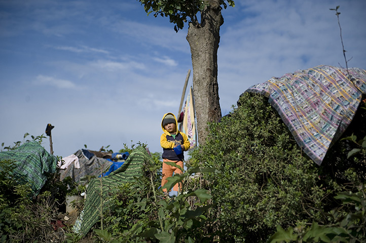 24 hours in pictures: A child looks in from a camp in Guatemala