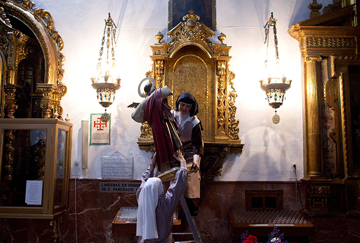 24 hours in pictures: Mexican cloister nuns hold a Saint Pancras image in Seville