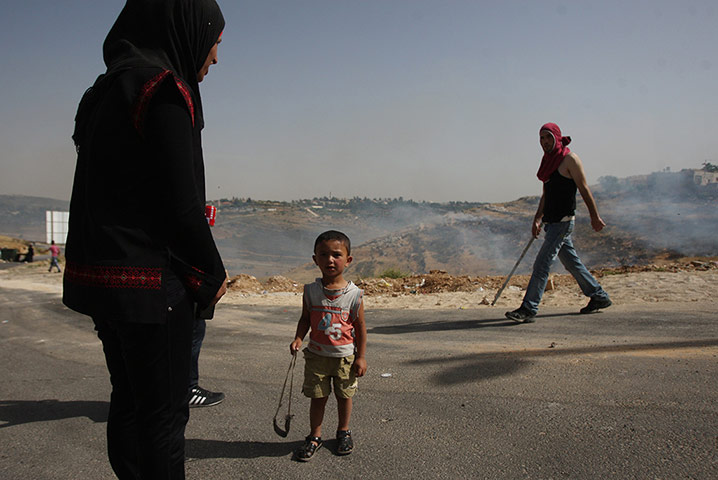 Picture Desk Live: A Palestinian child holds a sling shot