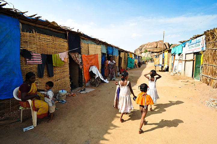 Hampi: Children walk through a temporary campsite at the Hampi bazaar