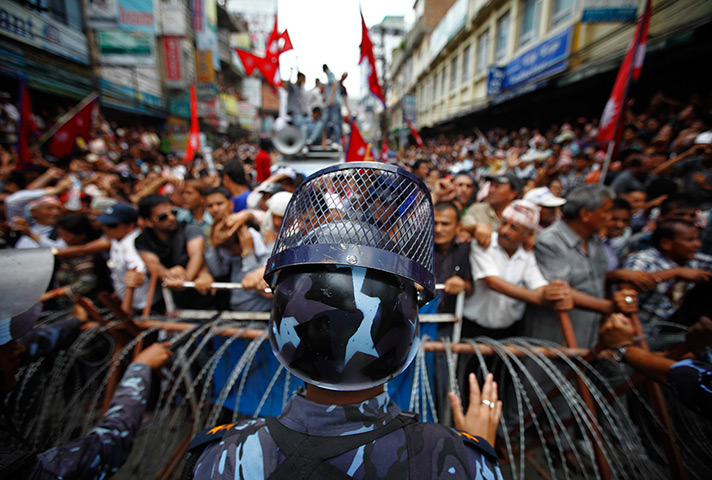24 hours: Kathmandu, Nepal: A riot police officer stands in front of barricades