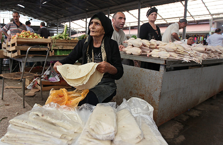 24 hours: Baku, Azerbaijan: A vendor sells hand-made bread at the central market