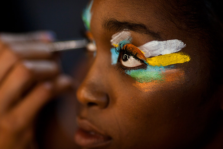 24 hours: Rio de Janeiro, Brazil: A stylist applies make-up to a model at Fashion Rio