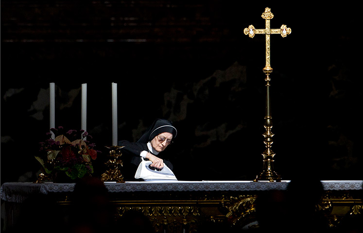 24 hours: The Vatican: A nun irons a secondary altar before the arrival of the Pope 