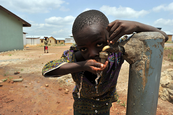 24 hours: Koidu, Sierra Leone: A boy drinks from a water tap